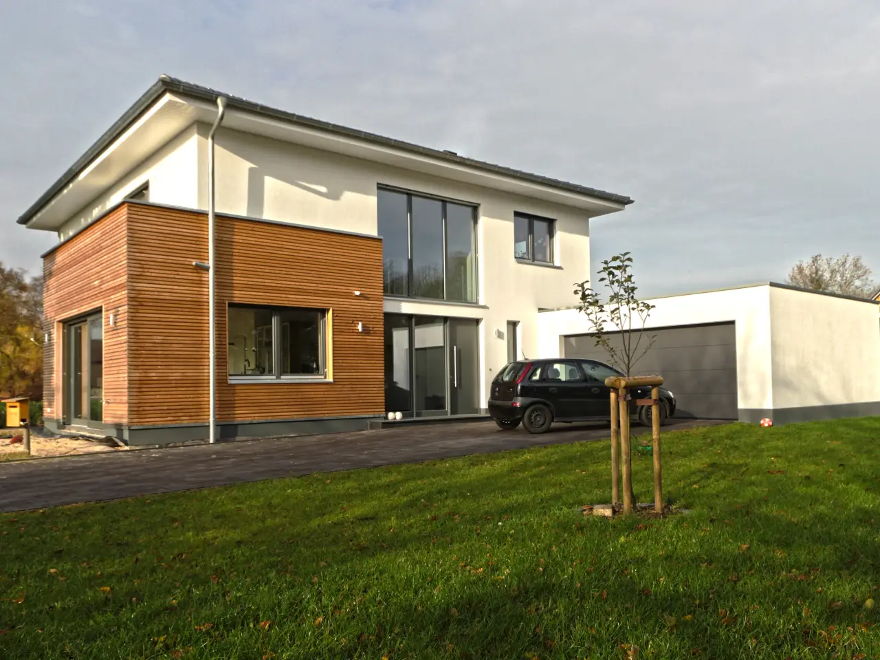 Garagenanbau mit Aufstockung in Bad Oeynhausen: Wohnhaus mit holzverkleidetem Anbau und Garage