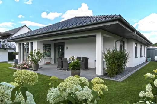Einfamilienhaus in Bad Oeynhausen: Bungalow mit Walmdach und überdachter Terrasse im Garten