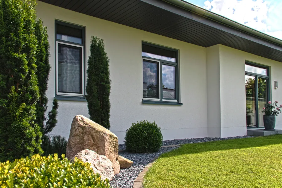 Einfamilienhaus in Bad Oeynhausen: Bungalowfassade mit Gartenbeet