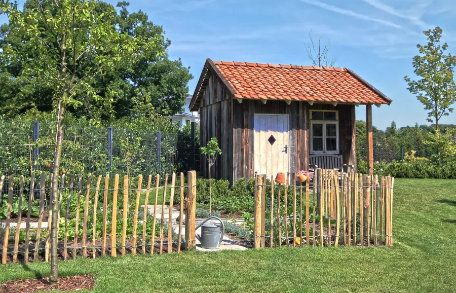 Landhausvilla in Minden: Gartenhaus aus Holz mit Staketenzaun