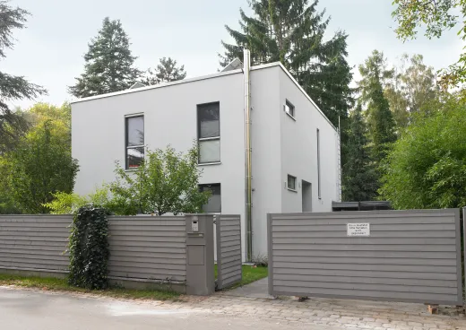 Einfamilienhaus in Berlin-Spandau: Kubisches Wohnhaus hinter grauem Holzzaun
